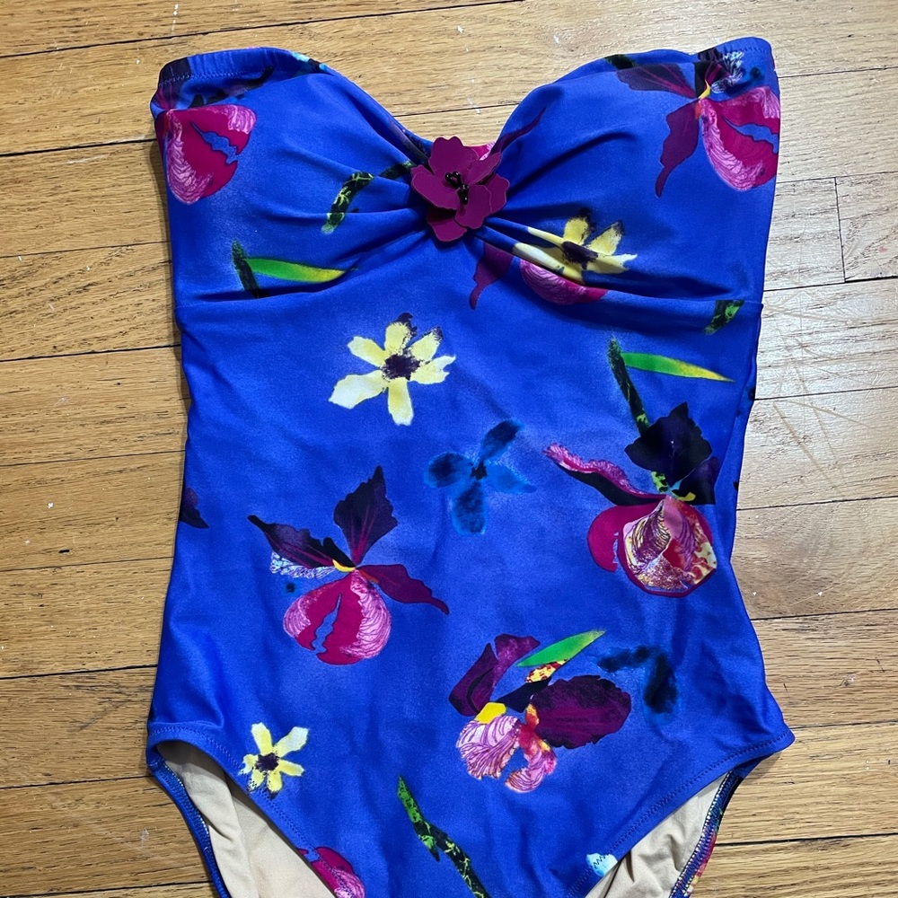 Floral bathing suit with flower accent. Sleeveless